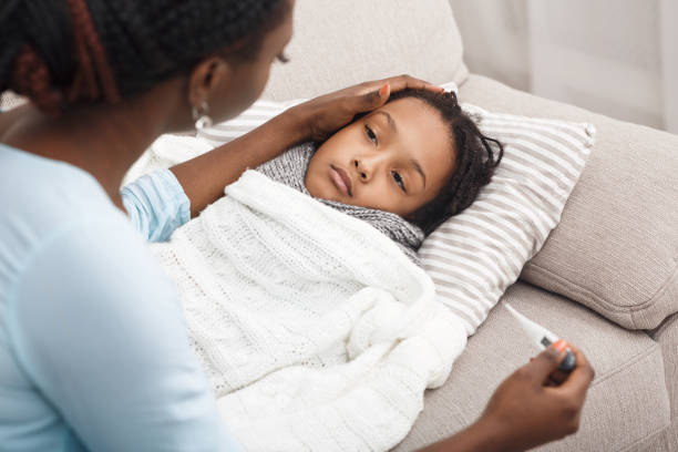 istock Mother checking temperature of her ill kid 1191437965