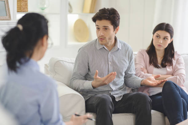 istock Young man explaining himself to family therapist 1191439789