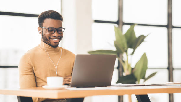 istock Smiling black student in glasses studying in bar 1191441964
