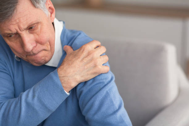 istock Senior Gentleman Having Shoulder Pain Sitting On Couch 1191442303