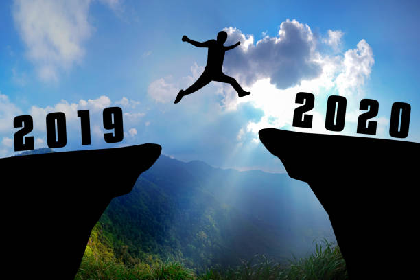 istock Silhouette young man jumping from 2019 to 2020 years 1191445384
