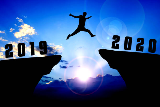 istock Silhouette young man jumping from 2019 to 2020 years 1191445400