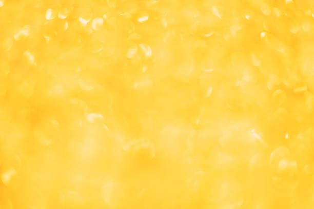 istock Festive bright yellow christmas blurred background with beautiful round bokeh 1191448220
