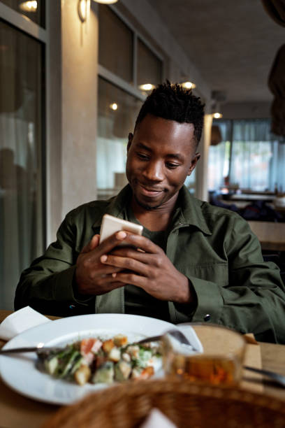 istock young african american man using laptop in cafe 1191449364