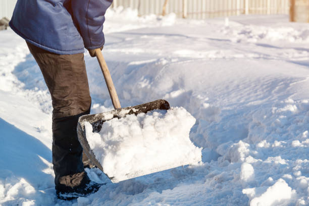 istock snow removal with a shovel from the road 1191449421
