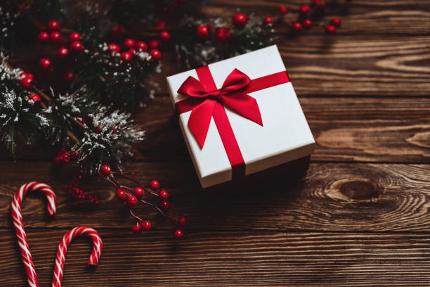 istock Christmas gift box. Christmas present in box at wooden table. 1191450269