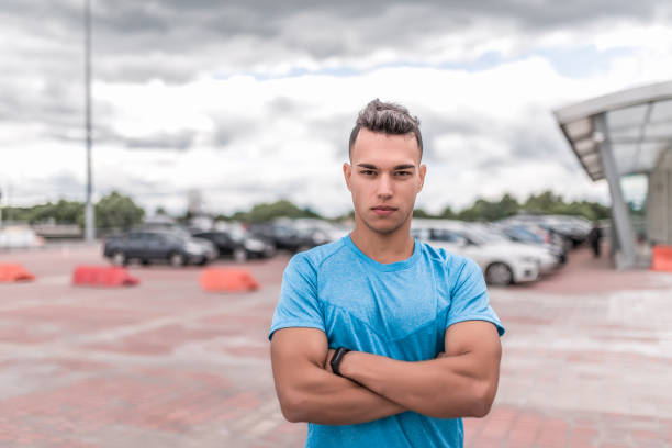 istock male athlete, resting after workout, looking confidently, strong and willed look, workout summer in the city. Fitness motivation youth lifestyle. Free space for copy text. 1191451382