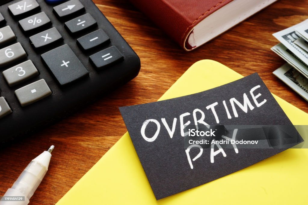 Text sign showing hand written words Overtime pay Working Late Stock Photo