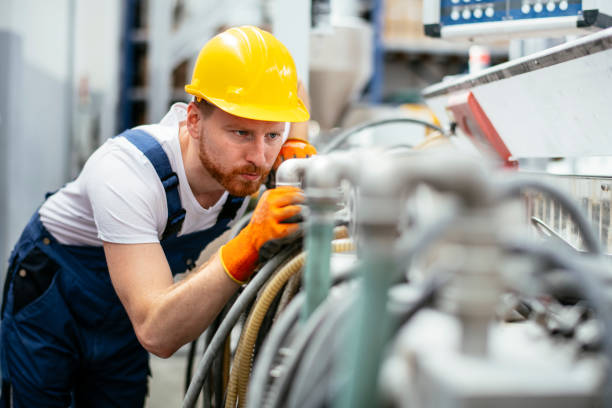 istock Worker in uniform working in factory 1191454493