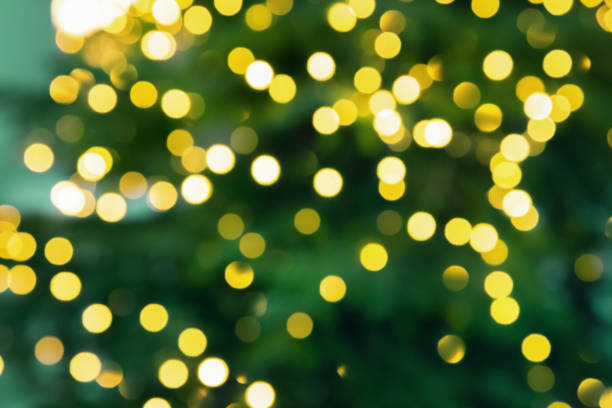 istock Christmas tree lights. Bokeh abstract texture. New Year background with bright yellow glitters. 1191454758