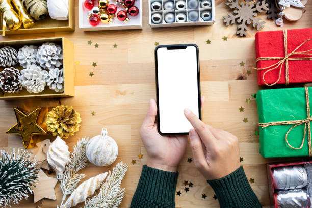 istock Merry christmas concepts with young female using smart phone with blank screen background and ornament element 1191455490