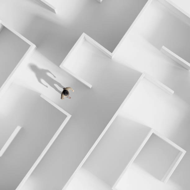 istock man walking in a white labyrinth, philosophical concept 1191458240