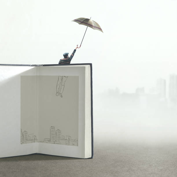 man with umbrella flying out of a illustrated book; surreal concept man with umbrella flying out of a illustrated book; surreal concept illusion photos stock pictures, royalty-free photos & images