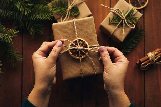 istock Top view of female hands while wrapping Christmas present 1191461098