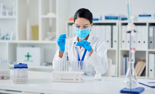 Changing the future one experiment at a time Shot of a young scientist conducting an experiment in a laboratory biochemist photos stock pictures, royalty-free photos & images
