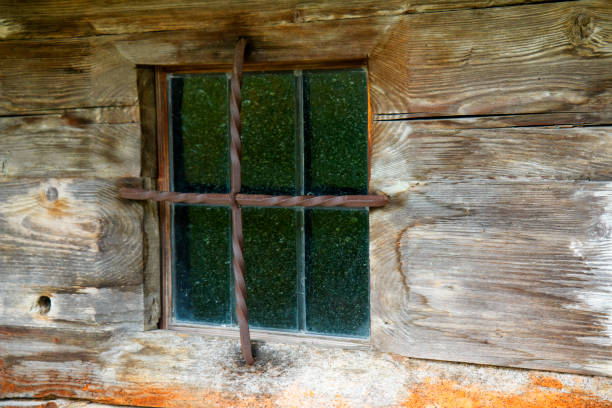 Window with hand blown glass panes at an old log cabin