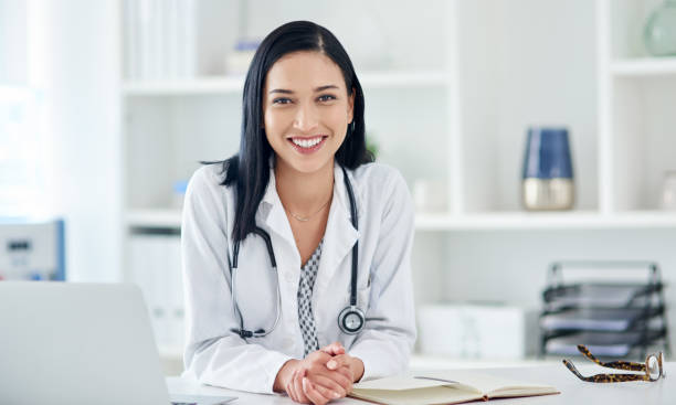 If it matters to you it matters to me Portrait of a young doctor working at her desk female doctor stock pictures, royalty-free photos & images