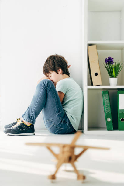 istock selective focus of sad kid with dyslexia sitting on floor 1191463801