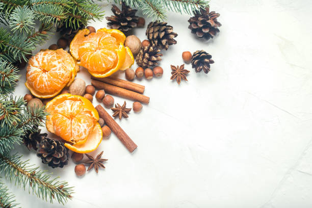 istock Tangerines without peel, Christmas tree branches, spices, cinnamon, cones on a white stone background. Concept of Christmas, New Year, Mulled Wine. Flat lay, top view. 1191465146
