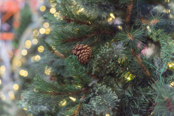 istock Artificial Christmas tree with pine cones and microdot pre-lit lights LED at hardware store in USA 1191467513