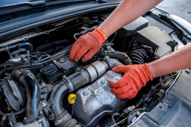 istock Human hands examining car engine in protective gloves close up 1191468314