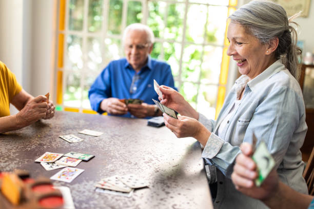 istock Seniors having fun playing cards in nursing home 1191468459