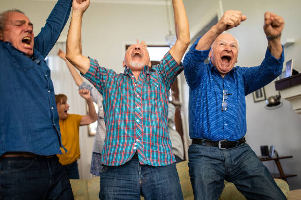 istock Senior people celebrating goal during match at home 1191468786