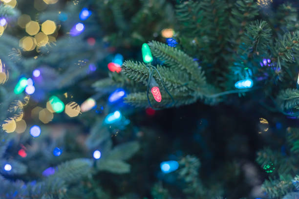 istock Close-up artificial Christmas tree and pre-lit color-changing lights LED at hardware store in USA 1191468789