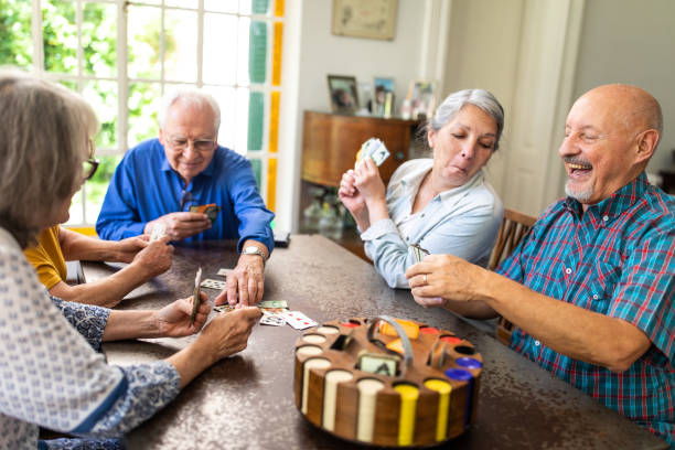 istock Senior people playing poker at home 1191468841
