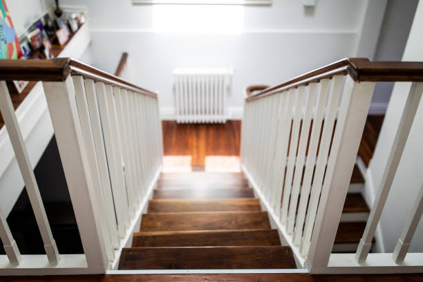 The view down a wooden stairway in house Modern wooden stairs and white walls, view from above house railing stock pictures, royalty-free photos & images