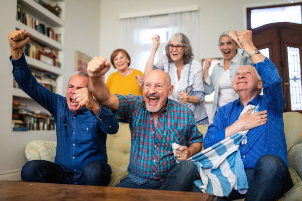 Senior friends supporting national team at home