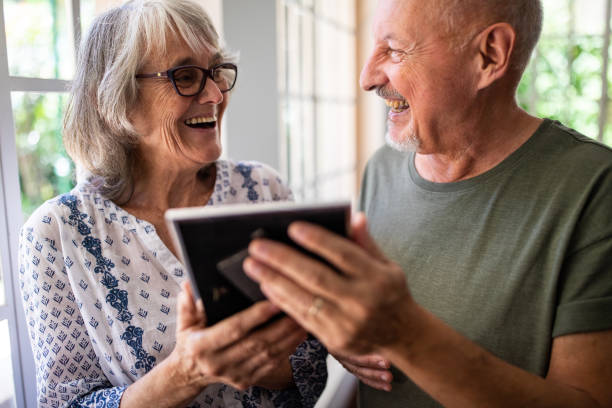 istock Senior couple looking at picture frame at home 1191469004