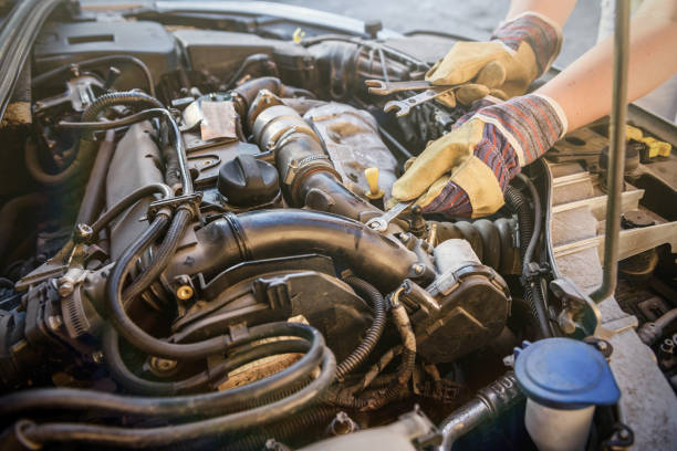 istock Hands with spanners and car engine close up. Car service concept 1191469099
