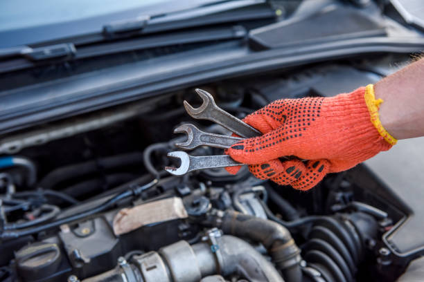istock Hands with spanners and car engine close up. Car service concept 1191469272