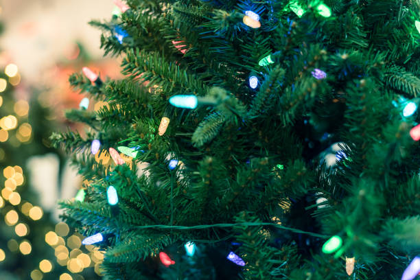 istock Close-up artificial Christmas tree and pre-lit color-changing lights LED at hardware store in USA 1191469884