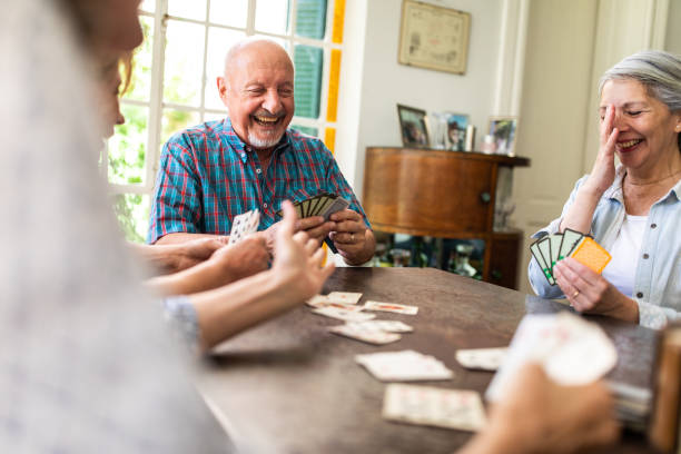 istock Joyful elderly people having fun with cards 1191471981