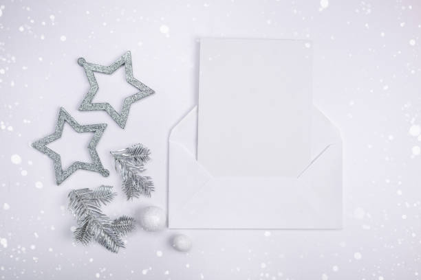 istock Flat lay compositions with Christmas decor with silver stars, silver spruce branches and a letter greeting card. Minimalism, copy space 1191472183