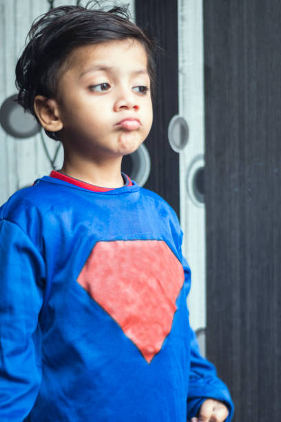 istock little boy dressed up as superhero costume 1191472844