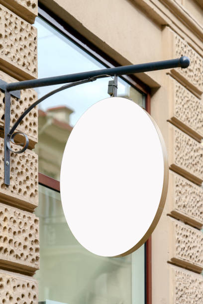 istock Mock up. Blank oval shape signboard on the wall of classical architecture building 1191472845