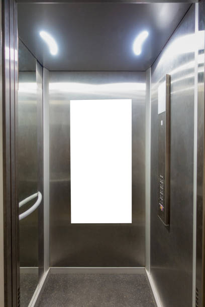 istock Mock up. Vertical poster media template frame hanging on the wall in elevator lift 1191474121