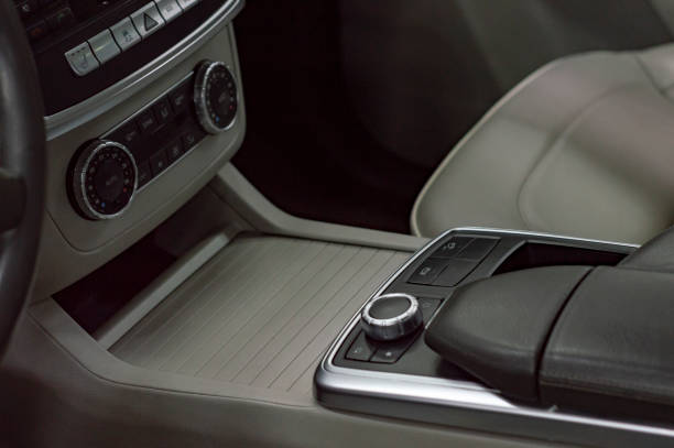 istock Interior of car. Panel with gear lever for transmitting box, dashboard, steering wheel, leather seats and armrest. 1191474644