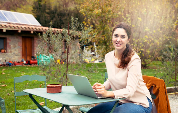 istock Young smiling woman working in the garden 1191477207