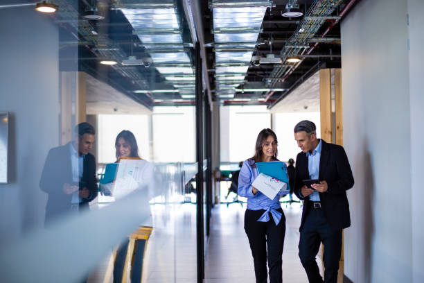 istock Two people discussing something about their work at the office 1191481827