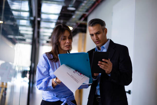 istock Two people discussing something about their work at the office 1191481870