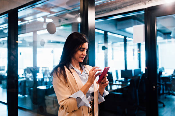 istock Businesswoman texting on mobile phone 1191487397