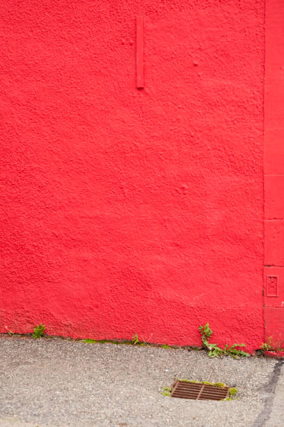 istock rustic wall of red painted building and a sidewalk 1191487510