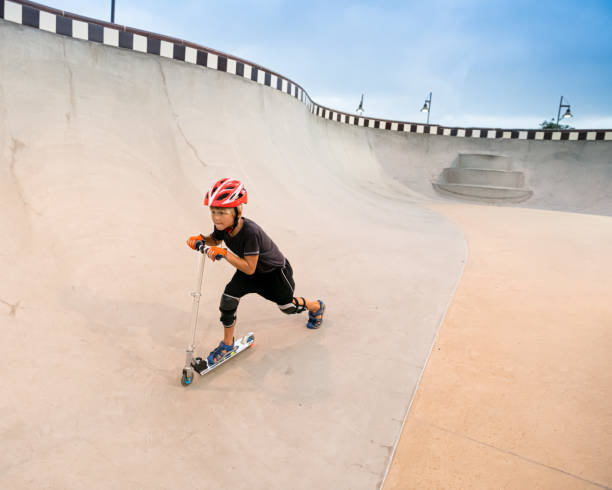 istock A 7 Year Old Boy On A Scooter At The Skate Park 1191487877