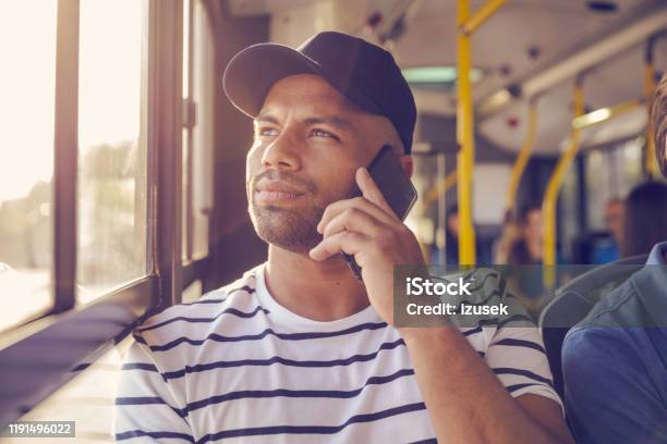 Man Talking On Mobile Phone In Bus Stock Photo - Download Image Now - 30-34 Years, Adult, Adults Only