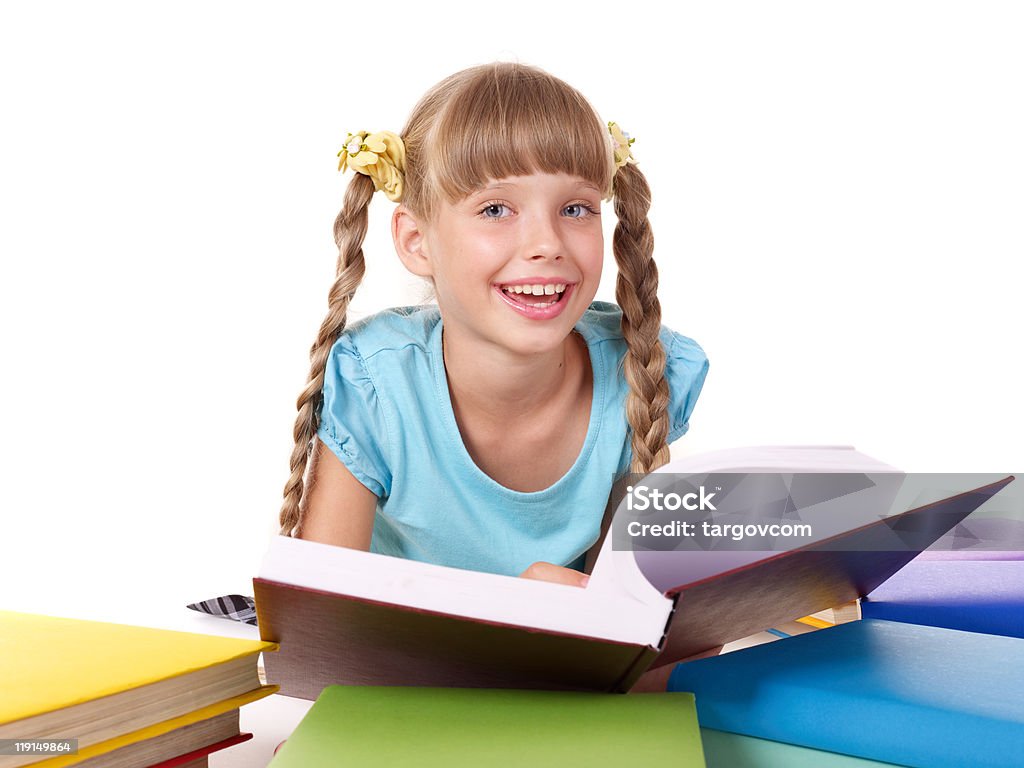 Child with pile of books reading on floor.  Book Stock Photo