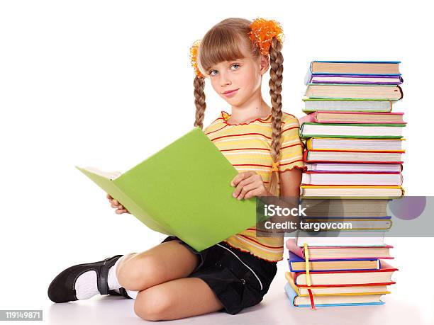 Foto de Criança Com Pilha De Livros De Leitura Em Andar e mais fotos de stock de Aluna - Aluna, Aluno de Primário, Amarelo